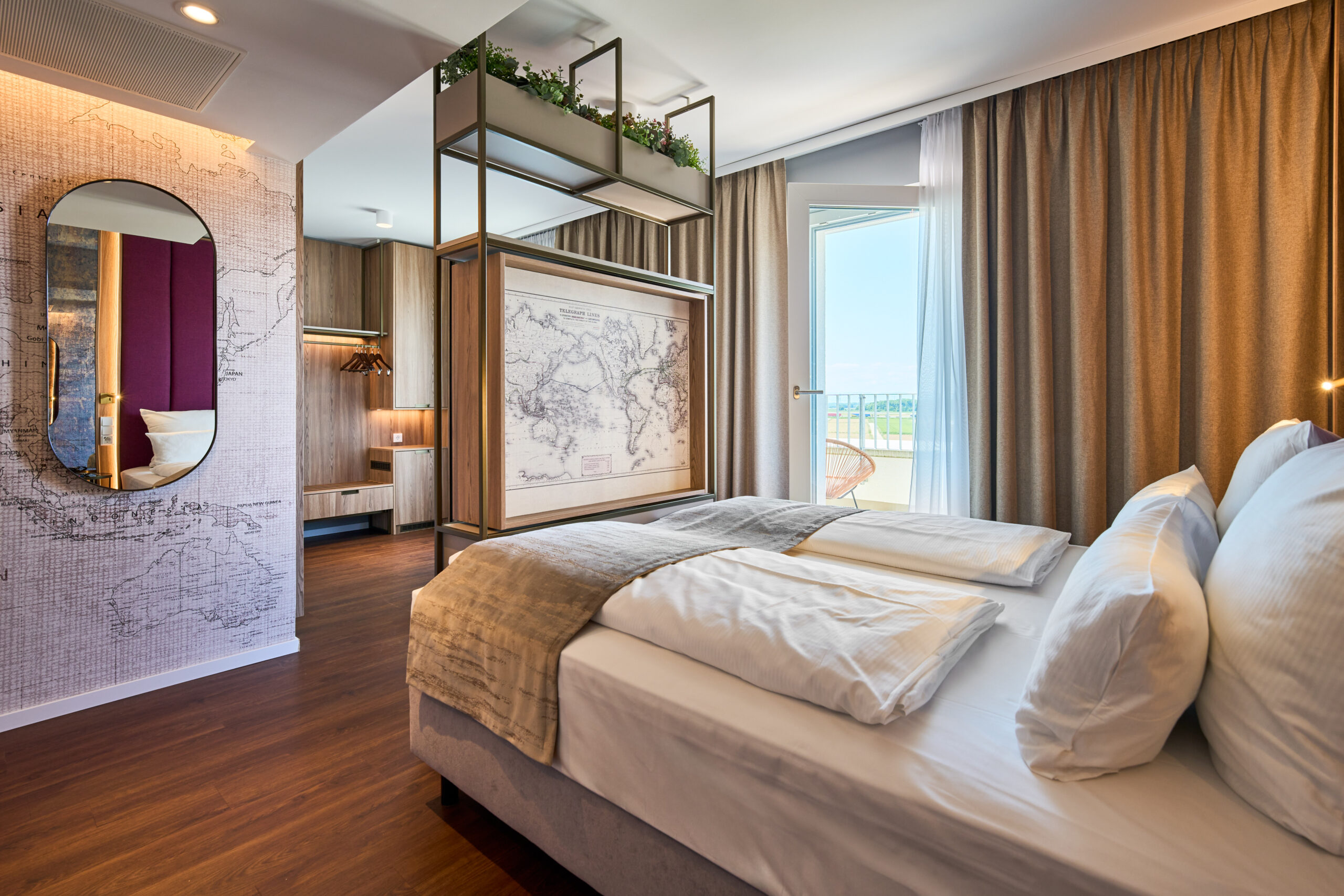 Hotelzimmer mit einem Doppelbett, einer Wandkarte und einem Spiegel im Hintergrund.